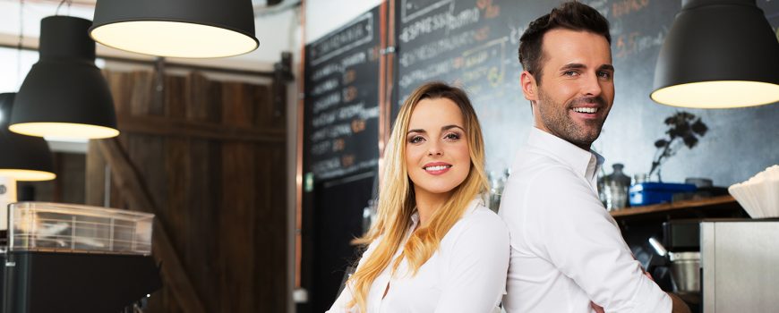 Small business partners standing together at their coffee shop, cafe